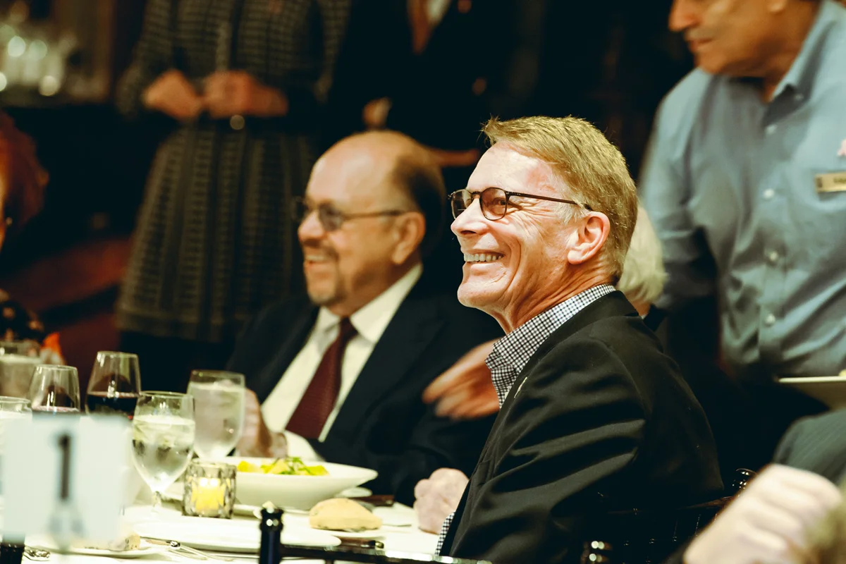 Men Smiling at Dinner Table